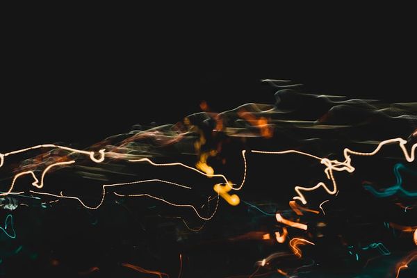 Minimalist amber glowing lines representing energy flow